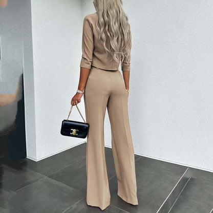 Elegant outfit with crop top and wide-leg pants.