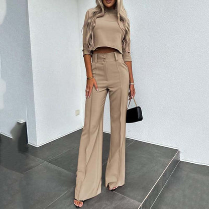 Elegant outfit with crop top and wide-leg pants.