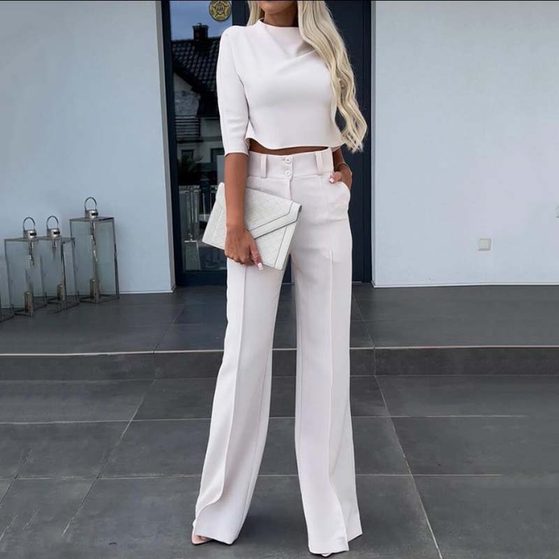 Elegant outfit with crop top and wide-leg pants.