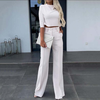 Elegant outfit with crop top and wide-leg pants.